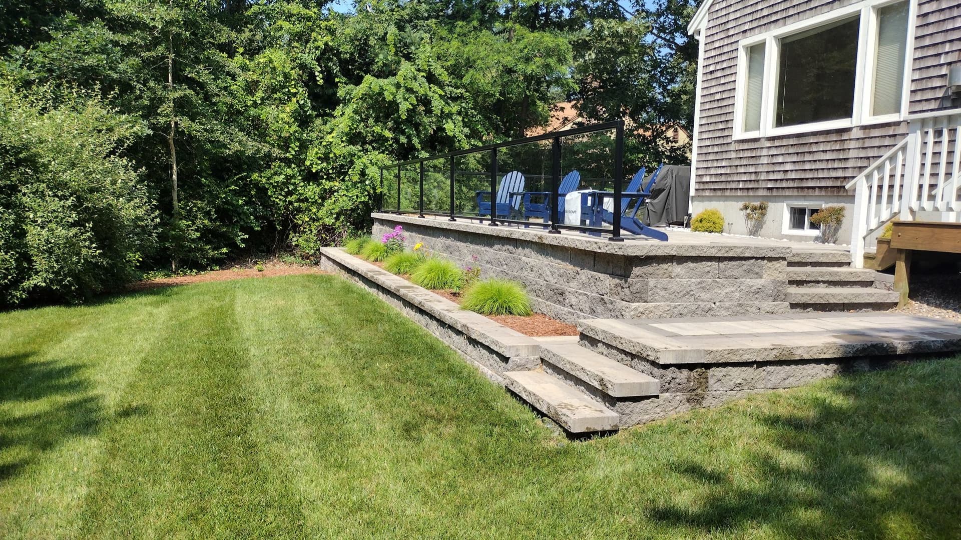 Backyard Makeover with Stone Patio and Planting Bed