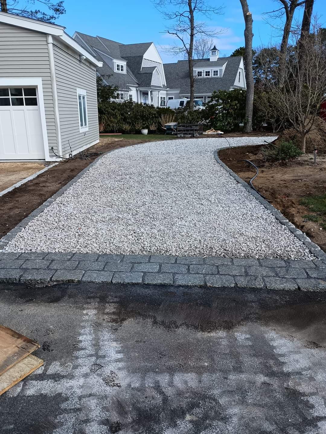 Driveway Installation with Cobblestone Accents